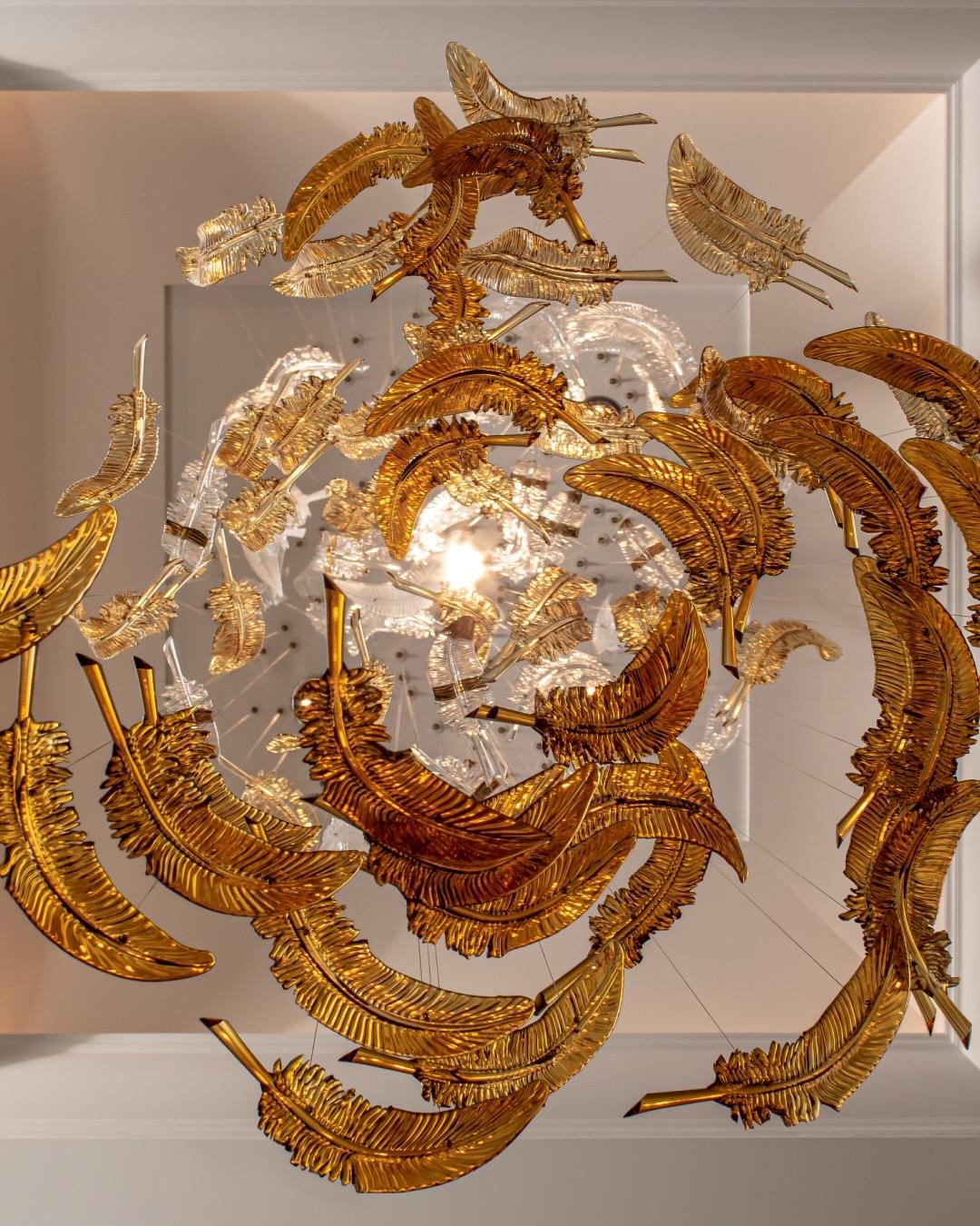 Modern designer chandelier suspended above marble dining table