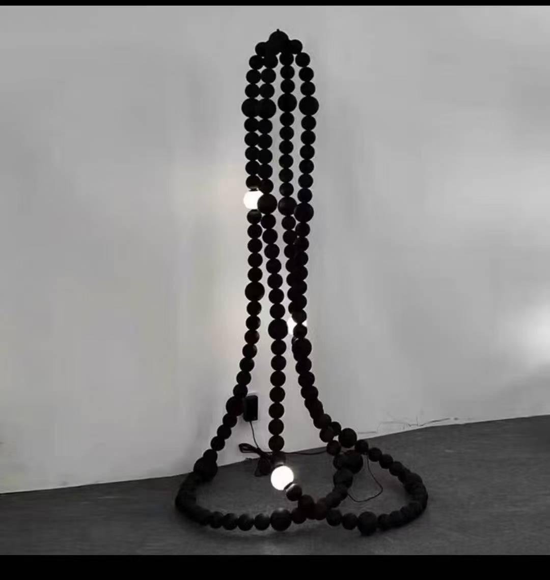 Noir bead column floor lamp sculptural floor lamp India designer floor lamp with bead structure lighting modern black floor lamp for living room India artistic floor lamp for gallery and studio interiors ambient lighting floor lamp with textured design contemporary sculptural floor lamp matte black finish decorative floor lamp for luxury interiors India premium floor lamp for hospitality and lounge spaces unique designer floor lamp for modern home décor statement floor lamp with bead column structure