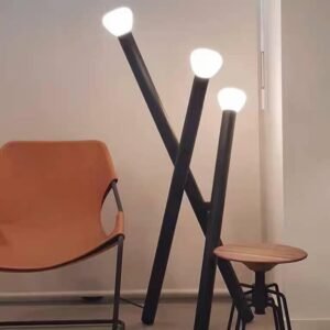 Axis Trio Floor Lamp – Modern Minimal Designer Floor Lamp for Contemporary Interiors Modern Floor Lamp with Minimal Architectural Design The Axis Trio Floor Lamp is a refined modern floor lamp that combines minimal structure with expressive design. Built with three gently intersecting stems, this designer floor lamp introduces subtle movement while maintaining a clean, architectural silhouette. Each light head emits a soft, diffused ambient glow, creating a balanced illumination that enhances the space without overpowering it—ideal for interiors that value calm, contemporary lighting. Designer Floor Lamp for Modern Homes in India Crafted with a durable metal body and diffused light heads, the Axis Trio Floor Lamp is designed to deliver both performance and aesthetics. The matte black finish adds depth and sophistication, making it a versatile fit for a wide range of modern interiors. Perfect for homes, studios, offices, and hospitality spaces across India, this lamp is ideal for spaces where lighting should feel intentional, minimal, and refined. Why Choose the Axis Trio Floor Lamp? • Clean modern floor lamp design with architectural form • Soft ambient LED-compatible lighting • Premium matte black finish for contemporary spaces • Multi-head structure for balanced light distribution • Ideal for minimal, modern, and creative interiors • Suitable for residential and commercial use in India Ideal Placement for Maximum Impact The Axis Trio Floor Lamp works best in: • Living room corners and lounge areas • Bedroom reading corners • Studio and creative workspaces • Office interiors and modern cabins • Minimalist homes and curated spaces Its design makes it a perfect accent floor lamp that blends seamlessly into modern layouts. Frequently Asked Questions (AEO Optimized) What type of lighting does the Axis Trio Floor Lamp provide? It provides soft ambient lighting, ideal for relaxed, comfortable environments. Is it suitable for small spaces? Yes, its slim, minimal structure makes it perfect for compact corners and modern layouts. Is installation complicated? No, it features a plug-and-play setup with foot/inline switch, making it easy to use. Designed for Clean, Contemporary Living The Axis Trio Floor Lamp is made for interiors that appreciate simplicity with character. It adds subtle visual interest while maintaining a calm and uncluttered look—perfect for modern homes and professional spaces. Product Specifications Product Type: Floor Lamp Design Style: Modern / Minimal / Contemporary Material: Metal Body with Diffused Light Heads Finish: Matte Black Finish Light Source: LED Compatible Lighting Effect: Ambient Glow Switch Type: Foot / Inline Switch Placement: Floor Standing Installation: Plug & Play Ideal For: Living Room, Bedroom Corner, Reading Area, Studio, Office Spaces
